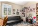 A fun bedroom with quirky decorations, a futon, and a bookcase filled with toys at 23791 W Magnolia Dr, Buckeye, AZ 85326
