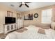 This cozy bedroom boasts neutral walls, plantation shutters, and a contemporary ceiling fan at 23791 W Magnolia Dr, Buckeye, AZ 85326