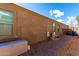 Exterior side view showcasing the property's design, with neatly laid brick path and functional features at 23791 W Magnolia Dr, Buckeye, AZ 85326