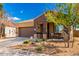 Inviting home with a cozy front porch and low-maintenance desert landscaping at 23791 W Magnolia Dr, Buckeye, AZ 85326