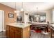 The kitchen island, with granite countertops, seamlessly connects the kitchen, dining area, and living room at 23791 W Magnolia Dr, Buckeye, AZ 85326