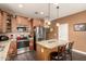 Well-lit kitchen features stainless appliances, breakfast bar with granite counters, and ample cabinet space at 23791 W Magnolia Dr, Buckeye, AZ 85326