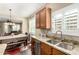 Kitchen featuring stainless steel appliances, granite countertops, and an open layout to the dining area at 23791 W Magnolia Dr, Buckeye, AZ 85326