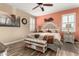 A staged main bedroom includes wood floors, a ceiling fan, and decorative furniture at 23791 W Magnolia Dr, Buckeye, AZ 85326