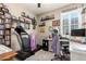 An organized home office with a treadmill, desk, and lots of shelving at 23791 W Magnolia Dr, Buckeye, AZ 85326