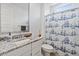 Bright bathroom with granite counters, decorative shower curtain, framed mirror, and white vanity at 24878 N 172Nd Dr, Surprise, AZ 85387