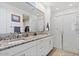 Elegant bathroom with double sinks, granite countertops, and a glass-enclosed shower at 24878 N 172Nd Dr, Surprise, AZ 85387