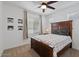 Cozy bedroom features a stylish bed, ceiling fan, and neutral decor, creating a tranquil retreat at 24878 N 172Nd Dr, Surprise, AZ 85387