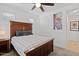 Comfortable bedroom features a well-made bed, ceiling fan, and a sliding-door closet at 24878 N 172Nd Dr, Surprise, AZ 85387