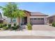 Charming single-story home featuring a brick facade, desert landscaping, and a two-car garage at 24878 N 172Nd Dr, Surprise, AZ 85387