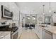 Contemporary kitchen featuring white cabinetry, an island, and an open layout to the dining area at 24878 N 172Nd Dr, Surprise, AZ 85387