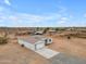 A modern single-story home situated on a spacious lot, featuring a long driveway and minimal landscaping at 28834 N 175Th Ave, Surprise, AZ 85387