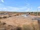 Sprawling property featuring a modern home with a light-colored exterior and a large, natural desert landscape at 28834 N 175Th Ave, Surprise, AZ 85387