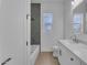 Bathroom featuring vanity with marble countertop, bathtub, and gray tile accent wall at 28834 N 175Th Ave, Surprise, AZ 85387