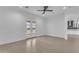 Spacious bedroom with ample natural light, tile floors, ceiling fan, and neutral color scheme at 28834 N 175Th Ave, Surprise, AZ 85387