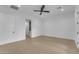 Spacious bedroom with ample natural light, tile floors, ceiling fan, and neutral color scheme at 28834 N 175Th Ave, Surprise, AZ 85387