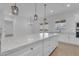 Open-concept kitchen island with pendant lighting next to the spacious dining area with backyard views at 28834 N 175Th Ave, Surprise, AZ 85387