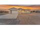 Single-story home featuring a clean white facade, modern garage door, and long concrete driveway at 28834 N 175Th Ave, Surprise, AZ 85387