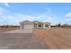 Single-story home with a modern design, light-colored exterior, and an attached garage with a concrete driveway at 28834 N 175Th Ave, Surprise, AZ 85387