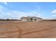 Modern single-story home with clean lines and a minimalist exterior, nestled in a natural desert landscape at 28834 N 175Th Ave, Surprise, AZ 85387