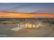 Stunning single-story home featuring a clean white facade, modern garage door, and picturesque desert surroundings at sunset at 28834 N 175Th Ave, Surprise, AZ 85387