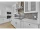 Contemporary kitchen design featuring herringbone backsplash, stainless steel hood, and sleek countertops at 28834 N 175Th Ave, Surprise, AZ 85387