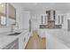 Bright white kitchen featuring modern appliances, tile backsplash, and views through the window at 28834 N 175Th Ave, Surprise, AZ 85387