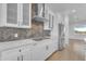 Modern kitchen boasts white cabinets, sleek stainless steel appliances, and stylish backsplash at 28834 N 175Th Ave, Surprise, AZ 85387