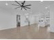 Spacious living room featuring an open floor plan, neutral color palette and large ceiling fan at 28834 N 175Th Ave, Surprise, AZ 85387