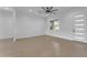 Spacious living area features a modern ceiling fan and large window showcasing outdoor views at 28834 N 175Th Ave, Surprise, AZ 85387