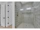 Modern shower enclosed in decorative tile, with glass door and bronze finish fixtures at 28834 N 175Th Ave, Surprise, AZ 85387