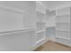 Organized walk-in closet with ample shelving and rods for clothing and storage at 28834 N 175Th Ave, Surprise, AZ 85387