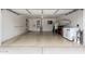 Spacious garage featuring epoxy flooring, storage, and garage door opener at 3423 E Crescent Way, Gilbert, AZ 85298