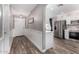 Hallway with wainscoting leading into kitchen with stainless steel appliances, perfect for entertaining at 3423 E Crescent Way, Gilbert, AZ 85298