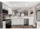 Bright kitchen with white cabinets, stainless steel appliances, and a view into another room at 3423 E Crescent Way, Gilbert, AZ 85298