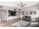 Spacious living room featuring a large media center, modern ceiling fan, and stylish decor at 3423 E Crescent Way, Gilbert, AZ 85298