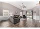 Cozy living room featuring hardwood floors, vaulted ceiling, and abundant natural light at 3423 E Crescent Way, Gilbert, AZ 85298