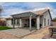 Inviting covered patio features a brick floor, contemporary pergola, and access to the home's interior at 3423 E Crescent Way, Gilbert, AZ 85298