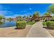 Picturesque pond with a walking path, lush landscaping, and calming water features at 3423 E Crescent Way, Gilbert, AZ 85298