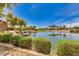 Scenic view of the community pond featuring rock waterfalls and mature landscaping at 3423 E Crescent Way, Gilbert, AZ 85298