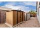 Backyard with metal shed and rock landscape at 3423 E Crescent Way, Gilbert, AZ 85298