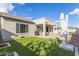 Relaxing backyard with synthetic grass and outdoor dining under a covered patio, ideal for entertaining at 3439 E Shannon St, Gilbert, AZ 85295