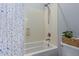 Well-lit bathroom with a shower-tub combo and a colorful shower curtain at 3439 E Shannon St, Gilbert, AZ 85295