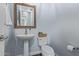 Charming powder room with pedestal sink and decorative accents at 3439 E Shannon St, Gilbert, AZ 85295