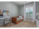 Neutral bedroom with a wooden daybed, desk, large window, and white curtains at 3439 E Shannon St, Gilbert, AZ 85295