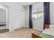 Well-lit bedroom with carpet, white closet doors, natural light, and views to another room at 3439 E Shannon St, Gilbert, AZ 85295
