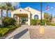 Community clubhouse featuring a covered entryway, lush landscaping and an American flag at 3439 E Shannon St, Gilbert, AZ 85295