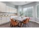 Bright dining area with a modern table setup, adjacent to kitchen with storage at 3439 E Shannon St, Gilbert, AZ 85295