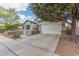 Wide driveway leads to a two-car garage, with mature trees in a well-maintained yard at 3439 E Shannon St, Gilbert, AZ 85295
