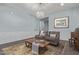 Cozy living room featuring two armchairs, an ottoman, and a stylish chandelier at 3439 E Shannon St, Gilbert, AZ 85295